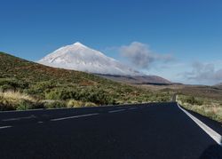 Countryside road near snowy mountain peak