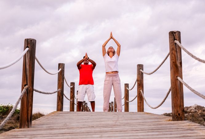Couple practicing martial arts on lumber path