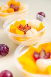 Three bowls of pudding fruit with a flower like shape from grape