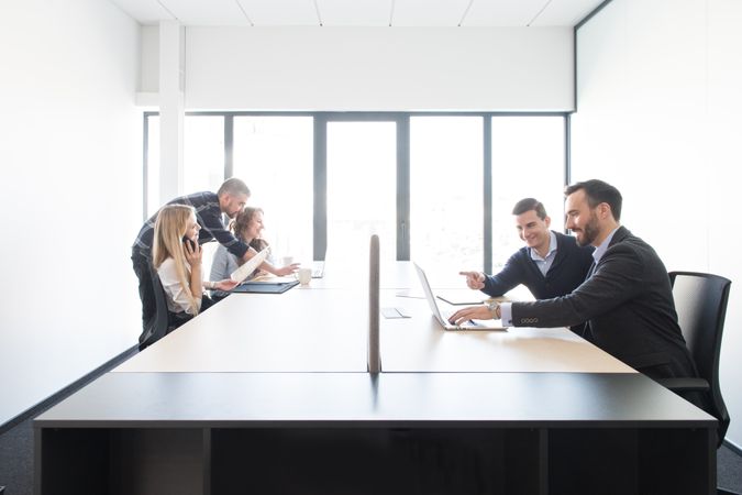 Smiling coworkers in teams inside of office