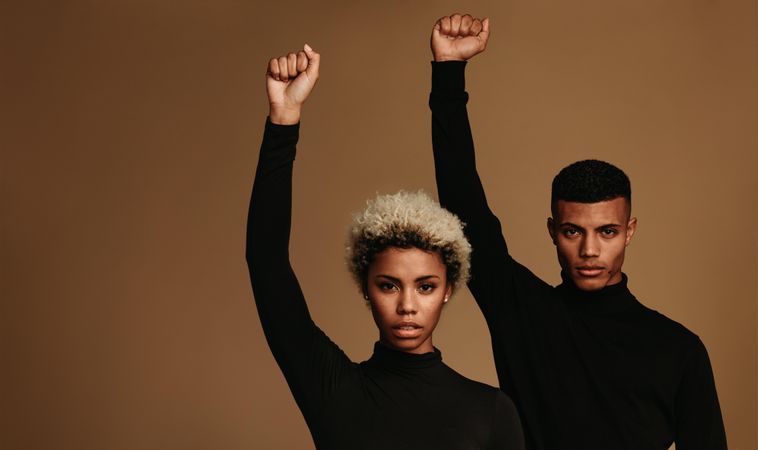 Couple with raised fists symbolizing fight against oppression