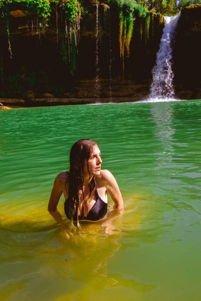 Woman standing in pool and looking away