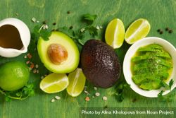 Ingredients for an avocado dish on green table 48v2k0