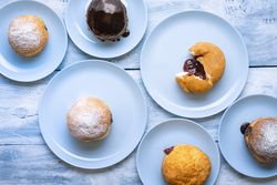 Homemade jelly donuts on monochrome blue layout