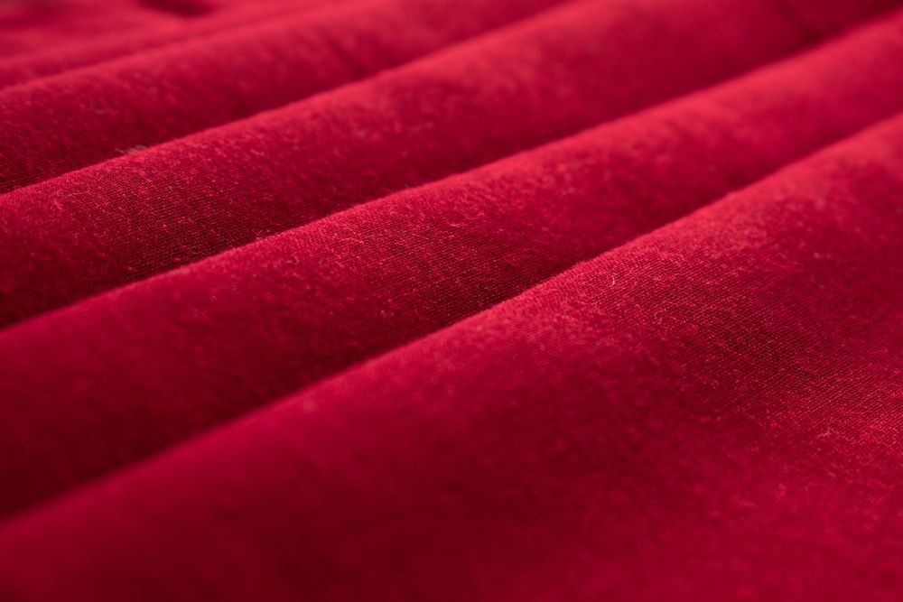 Close up Red folded Fabric Background Texture.