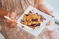 Crop woman eating delicious dessert