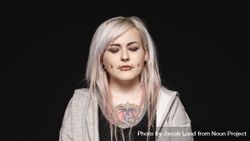 Woman with white hair and tattoo on body with her eyes closed 5zQnn0
