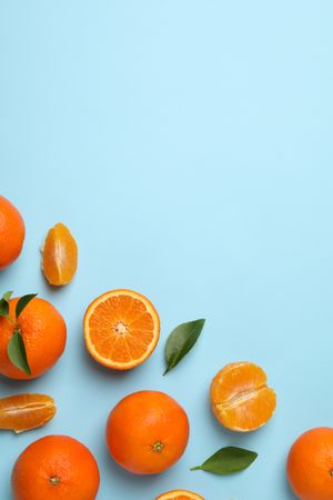 Ripe sweet mandarins on blue background, top view