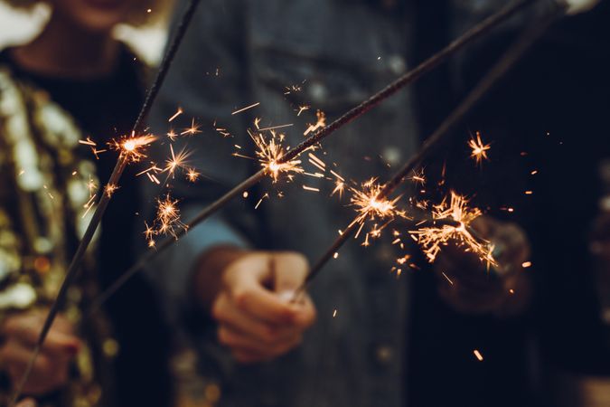 Close up of friends with sparklers in hand