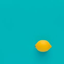Lemon on bright blue background