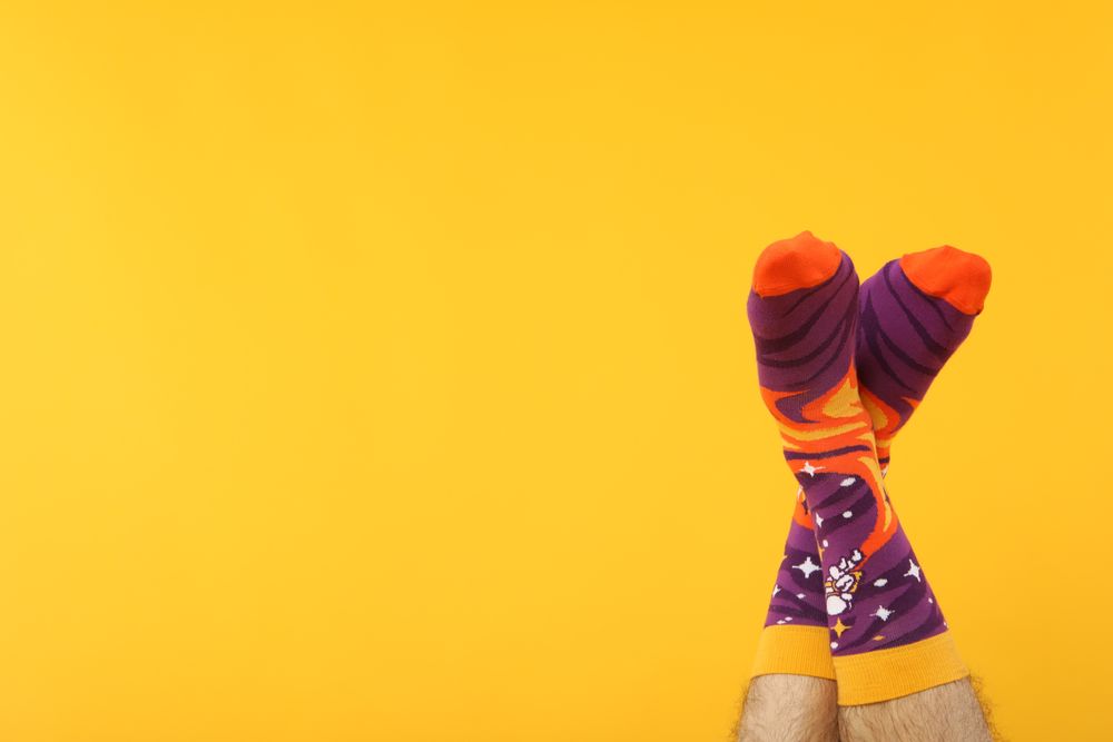 Casual clothes and wearing concept - socks, clothes for foot