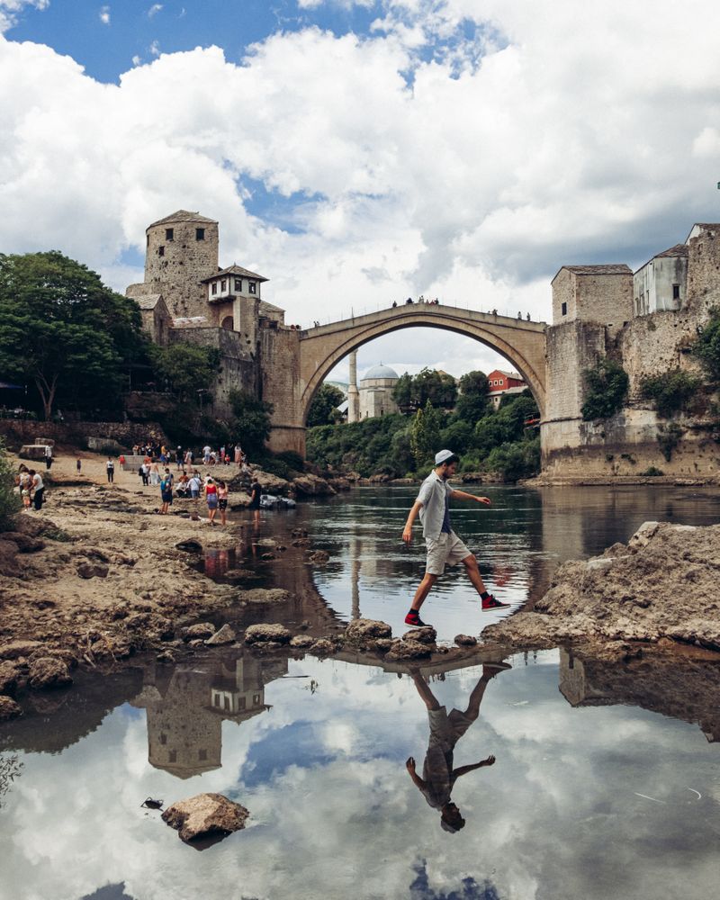 Man walking near Mostar Bridge in Bosnia