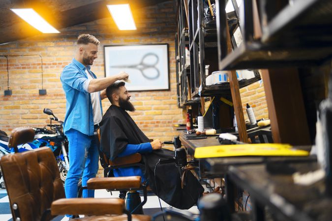 Barber cutting a bearded man’s hair