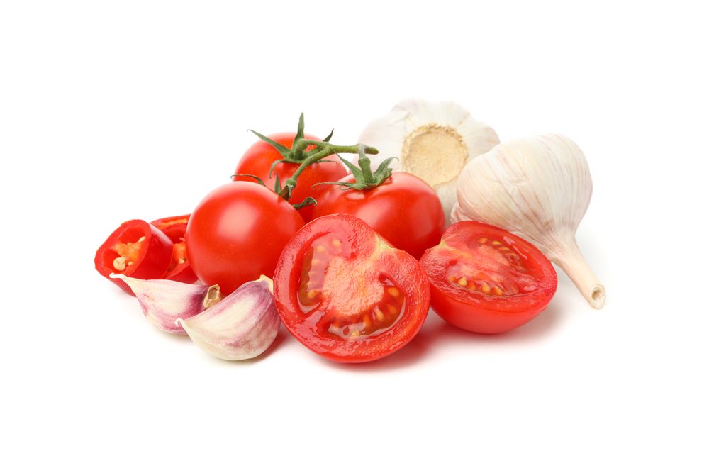 Tomatoes and garlic isolated on neutral background