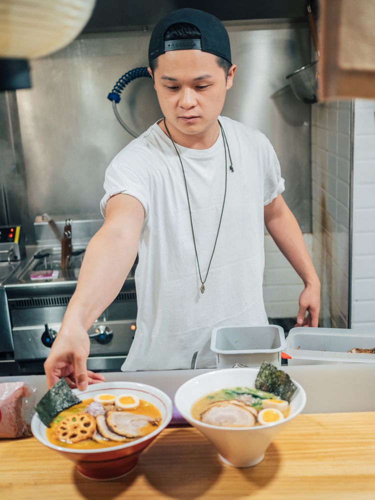 Asian chef with served bowls of ramen