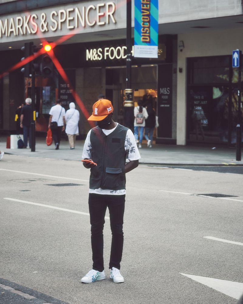 London, England, United Kingdom - September 18 2021: Man checking phone on the street