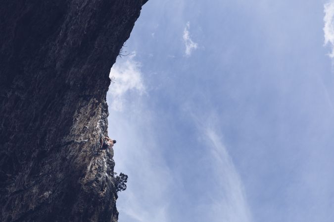 Anonymous man climbing rock