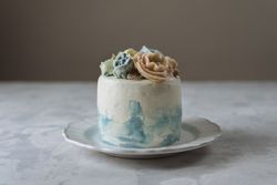 Buttercream flowers cake, blue and pastel peach colors