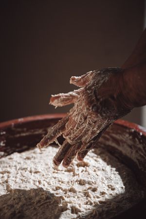 Cropped image of a person kneading dough