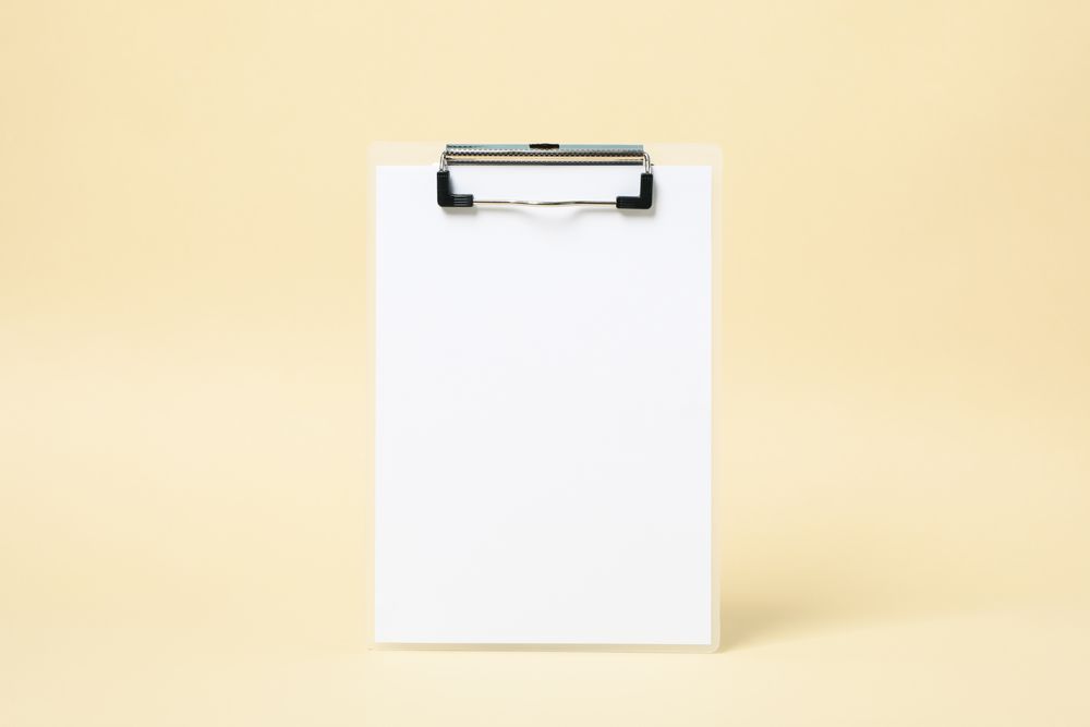 Empty clipboard on beige background, space for text