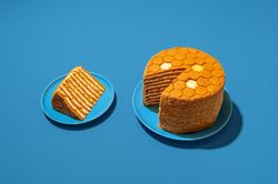 Sliced honey layered cake, russian recipe, in bright light on a blue table