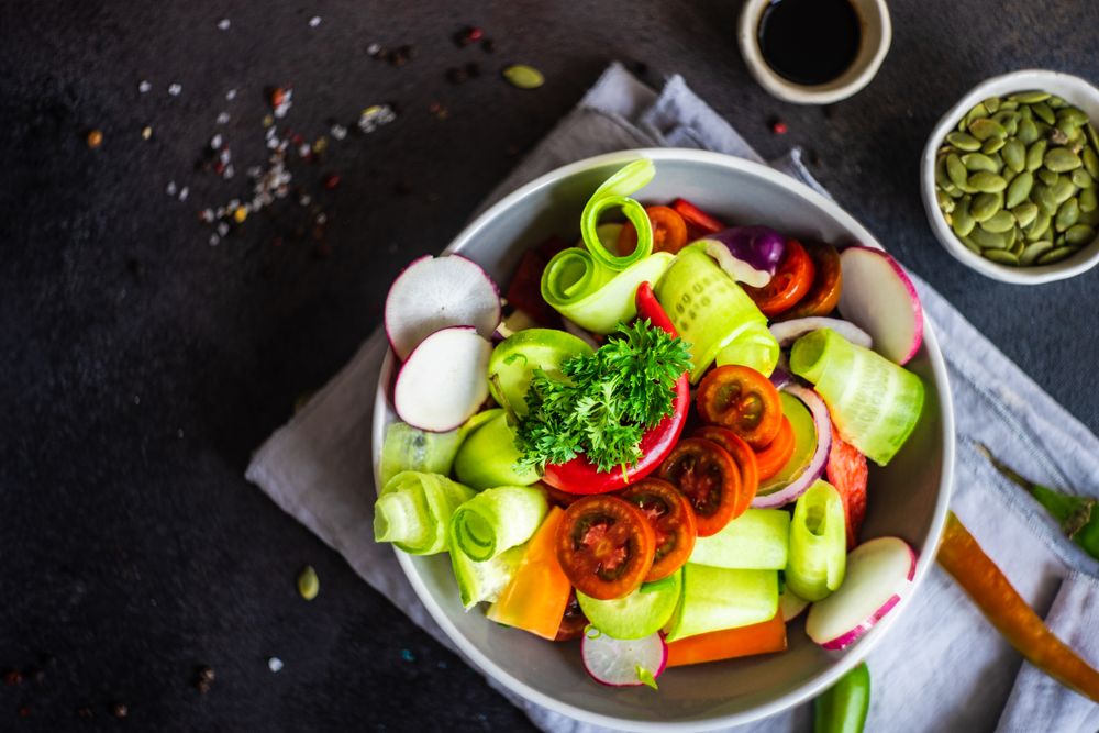 Top view of fresh raw salad with freshly chopped vegetables