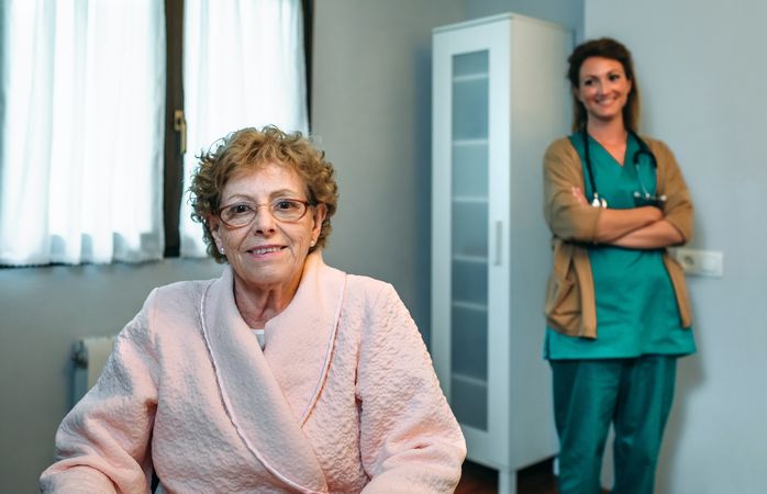 Patient posing with doctor in the background