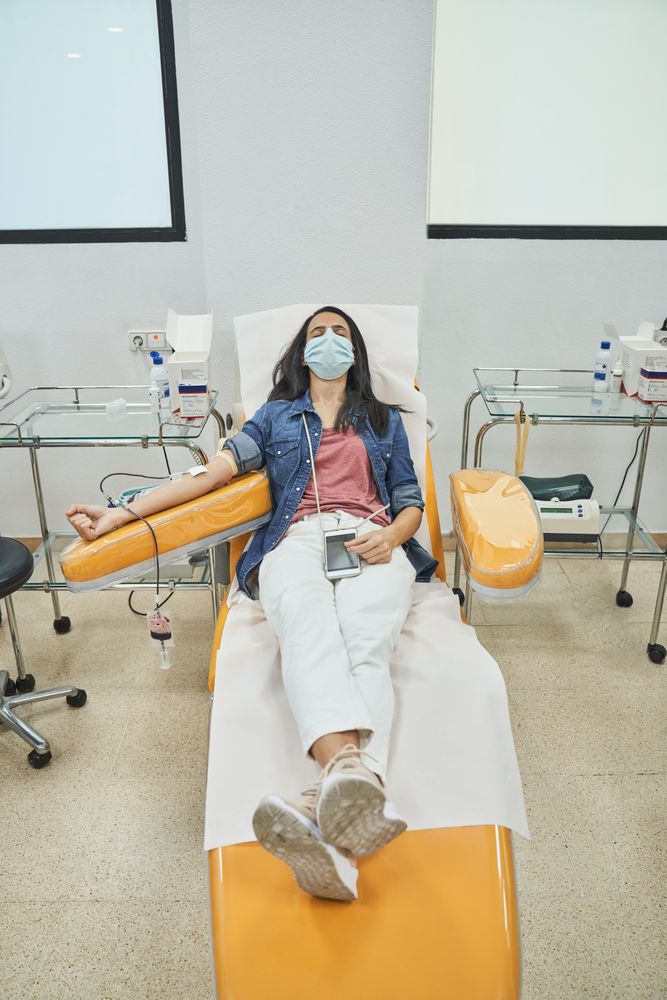 Female patient donating blood from vein