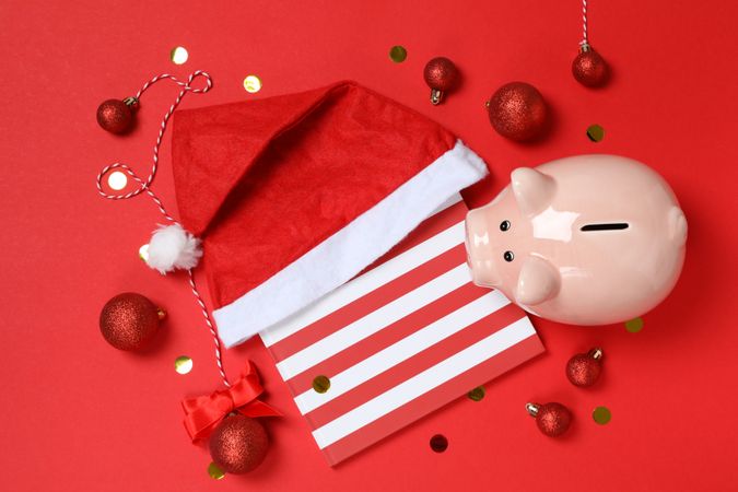 Concept of Christmas finance with piggy bank, top view