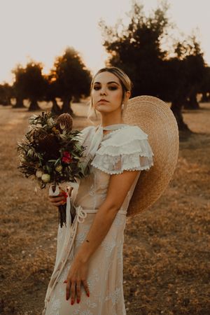 Woman in dress with flower bouquet