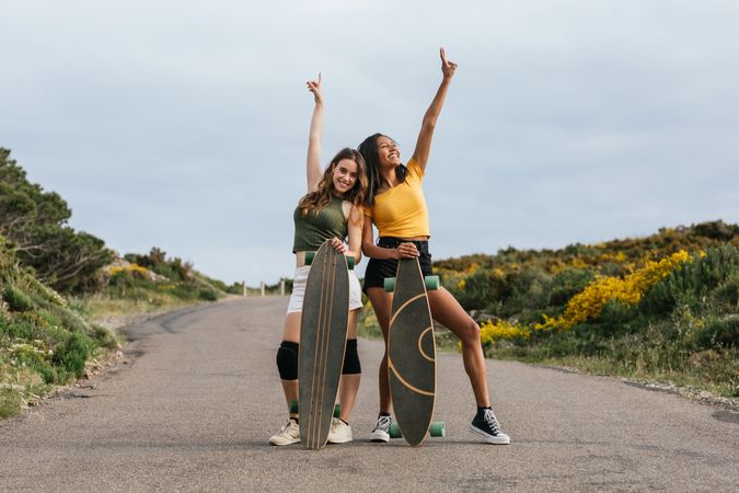 Cheerful diverse women standing on the road
