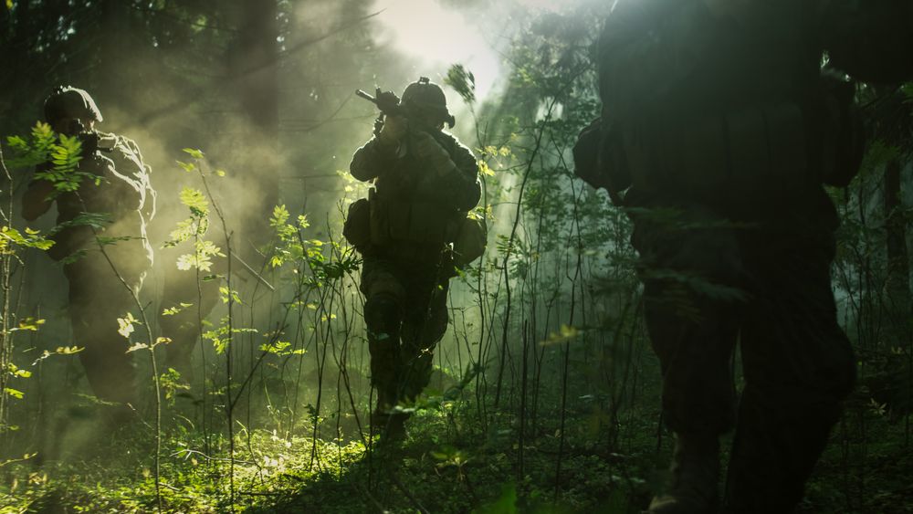 Fully Equipped Soldiers Wearing Camouflage Uniform Attacking Enemy, Rifles Ready to Shoot.