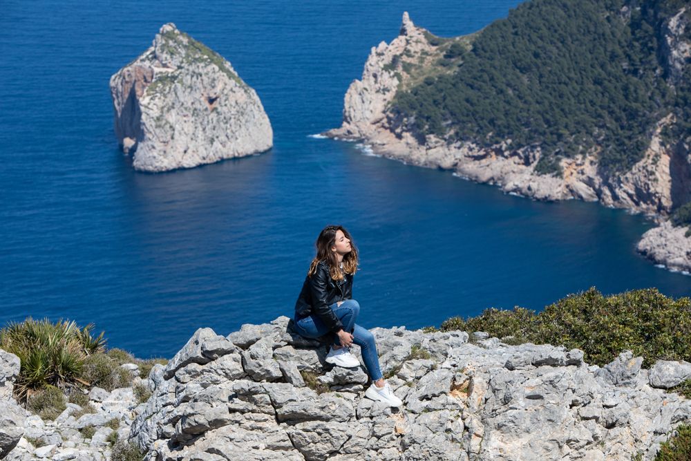 Young woman resting on cliff