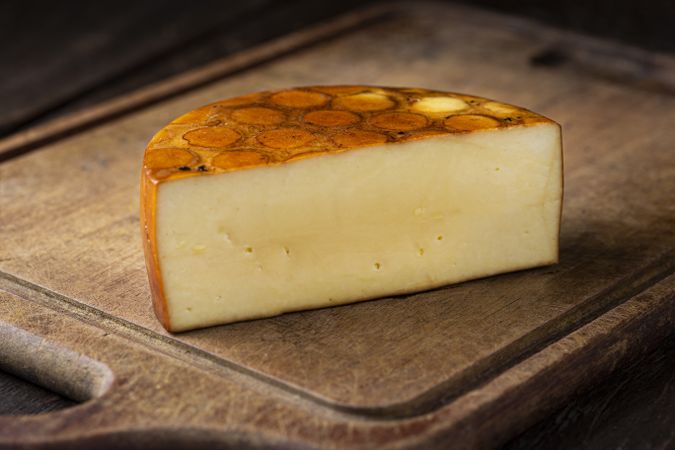 cheese round half on bread board