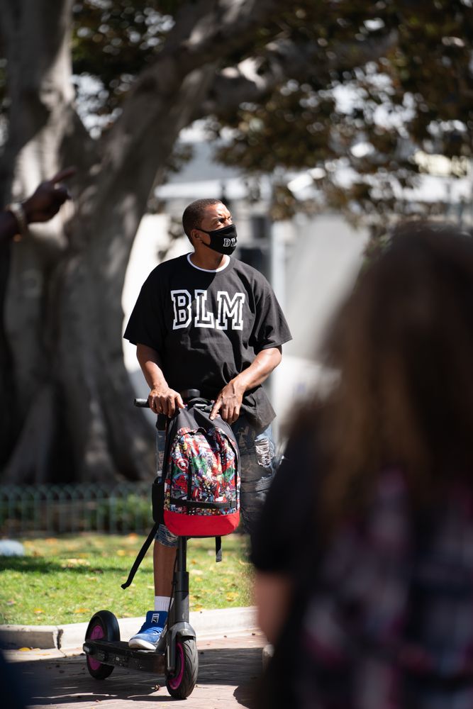 Los Angeles, CA, USA — June 16th, 2020: man on scooter listens to speakers at protest rally