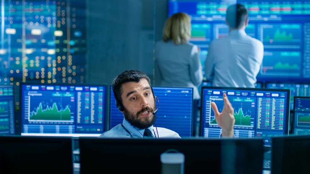 Stock Exchange Trader Makes a Deal with Big Client Over the Headset.