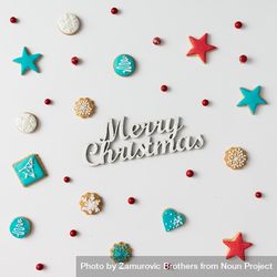 Christmas cookies and red berries with “Merry Christmas” text 4BqpM5