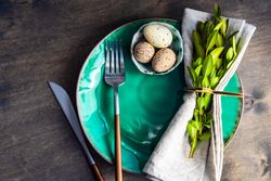 Festive table setting with eggs and leafy branch for spring