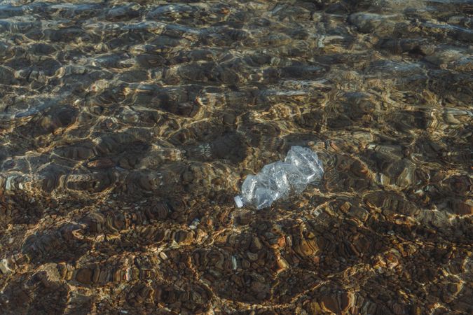 Plastic bottle lying on seashore