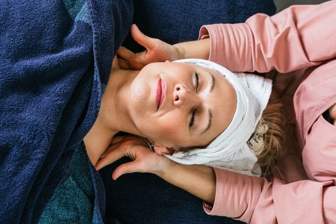 Anonymous masseuse doing massage for woman in spa salon