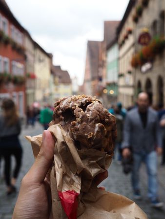 a Delicious Chocolate Waffle Ice Cream with crowd in a soft-focus street situation in the background.