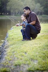 Happy Young Father and Son Fishing
