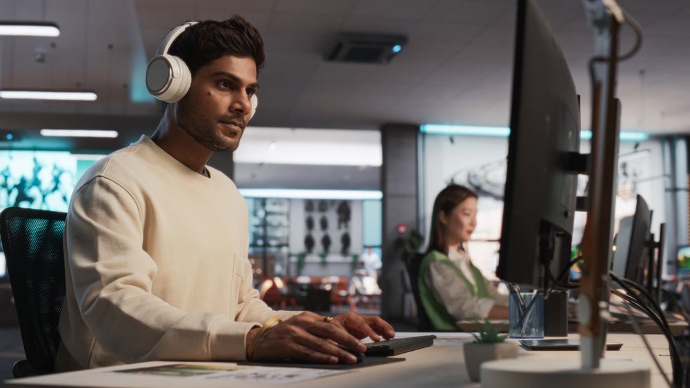 Indian Male Game Designer Using Desktop Computer With 3D Modelling Software To Design Unique Characters And World For Immersive RPG Video Game.