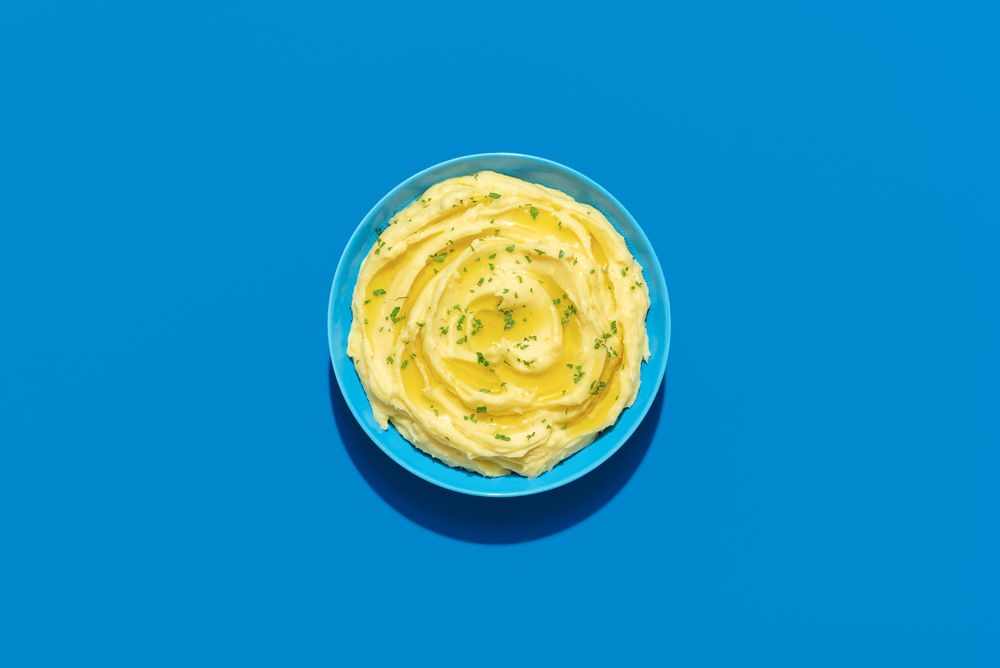 Mashed potatoes above view on a blue background