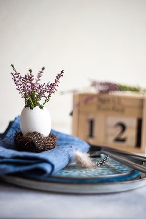 Easter table setting with side view of heather in decorative egg