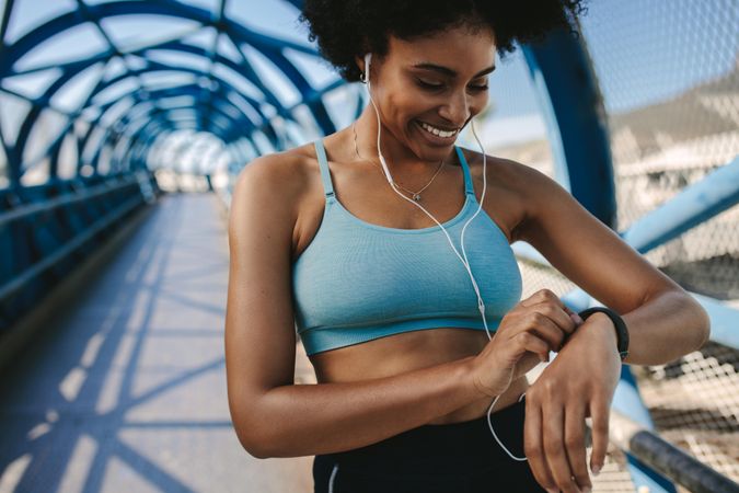 Woman smiling checking watch timer after run