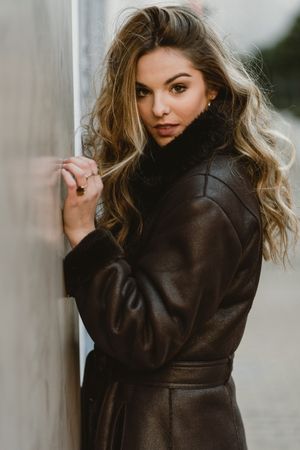 female standing on city street