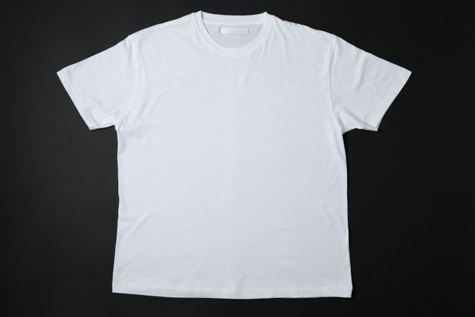 Blank plain t-shirt on dark background, space for text