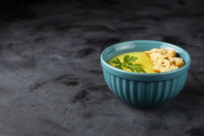 Bowl with onion soup and croutons on the table.