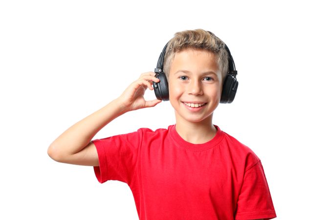 Boy in red t-shirt with headphones isolated on blank background